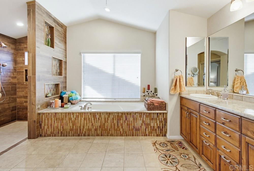 3930 Via Palo Verde Lago Alpine, CA 91901 - Photo 42 of 75 a bathroom with a tub sink and mirror