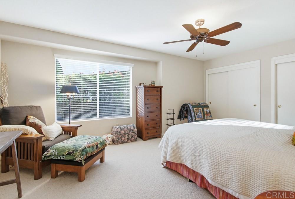 3930 Via Palo Verde Lago Alpine, CA 91901 - Photo 45 of 75 a bedroom with a bed a couch and a large window