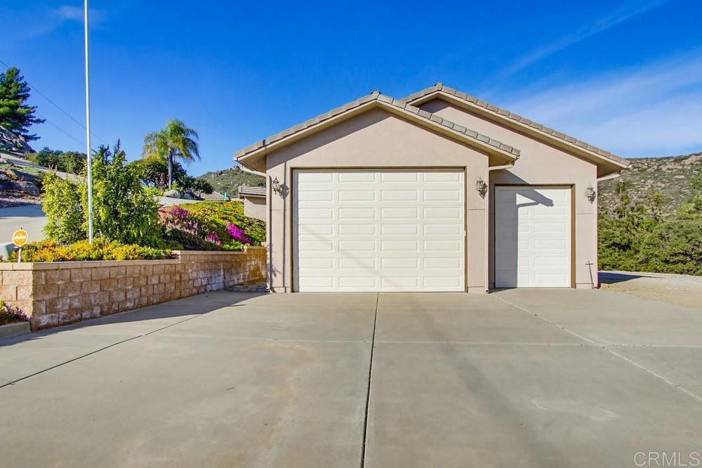 3930 Via Palo Verde Lago Alpine, CA 91901 - Photo 66 of 75 a front view of a house with a yard and garage