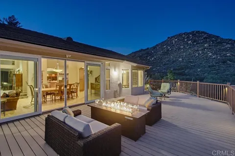 a view of a chairs and table in patio