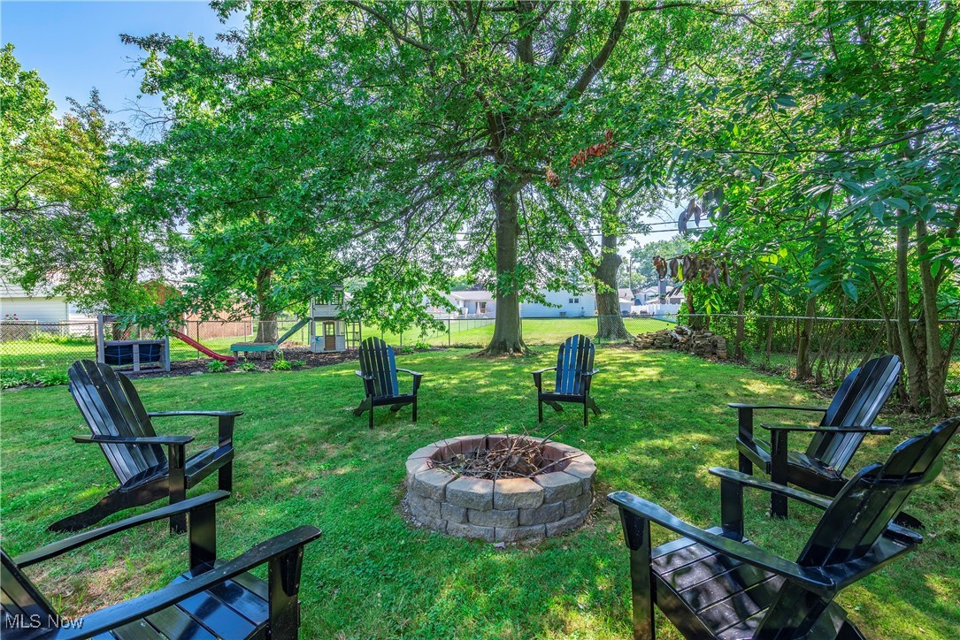 1605 Lander Road Cleveland, OH 44124 - Photo 33 of 38 View of yard featuring an outdoor fire pit and a playground
