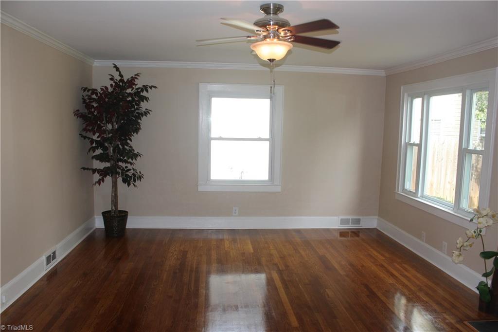 5650 Reynolda Road Winston-Salem, NC 27106 - Photo 3 of 21 Beautifully refinished hardwoods..this living room would be a welcome sight after a long day.