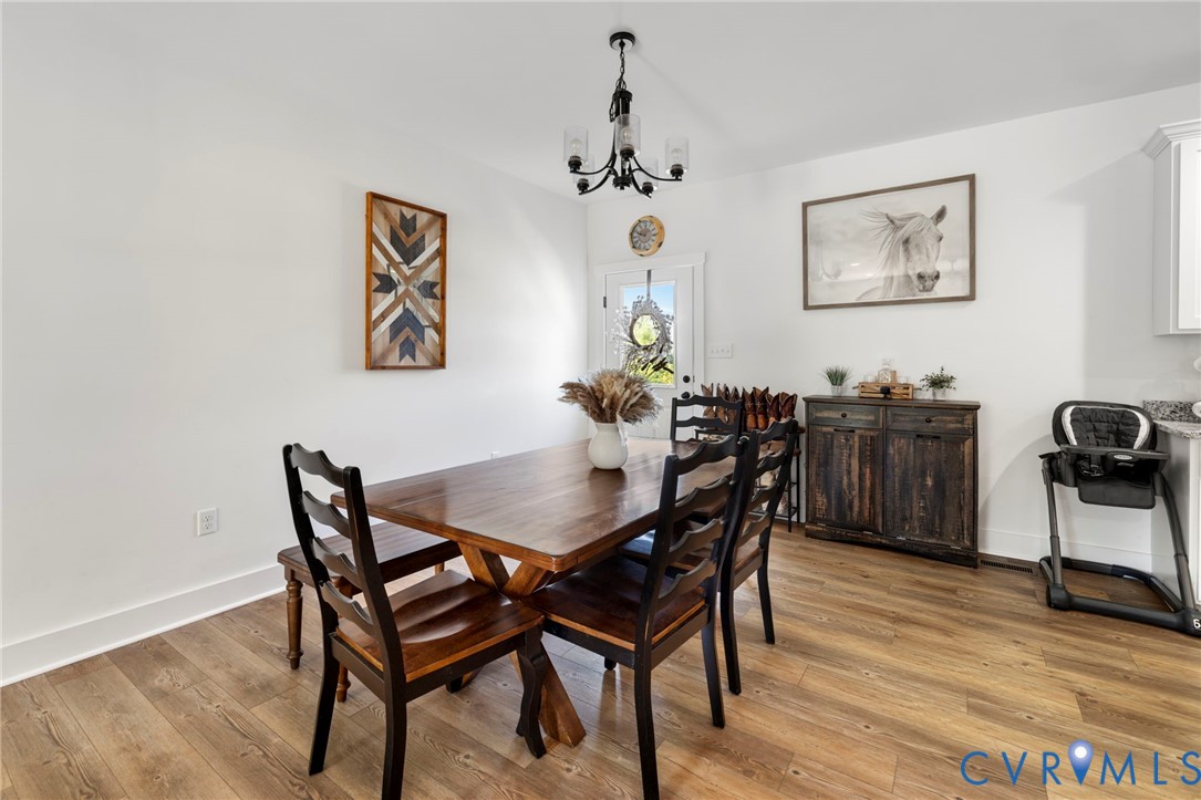 77 Jenkins Church Road Cumberland, VA 23040 - Photo 13 of 46 a view of a dining room with furniture and wooden floor