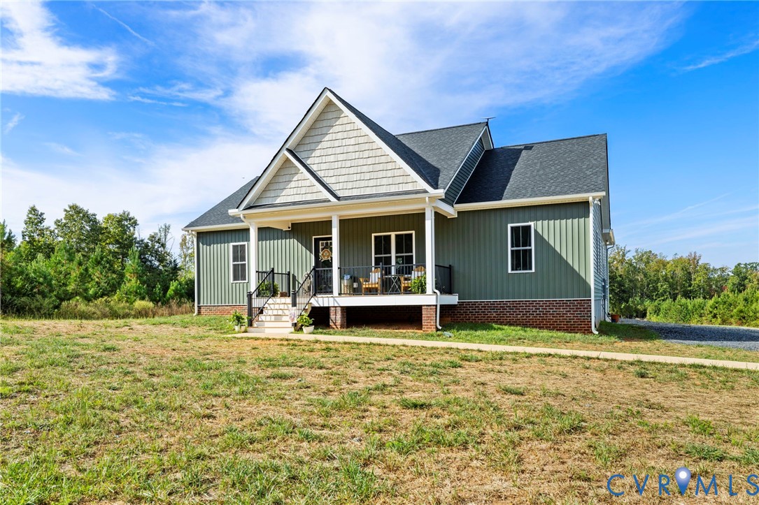 77 Jenkins Church Road Cumberland, VA 23040 - Photo 4 of 46 a front view of a house with a yard garage and outdoor seating