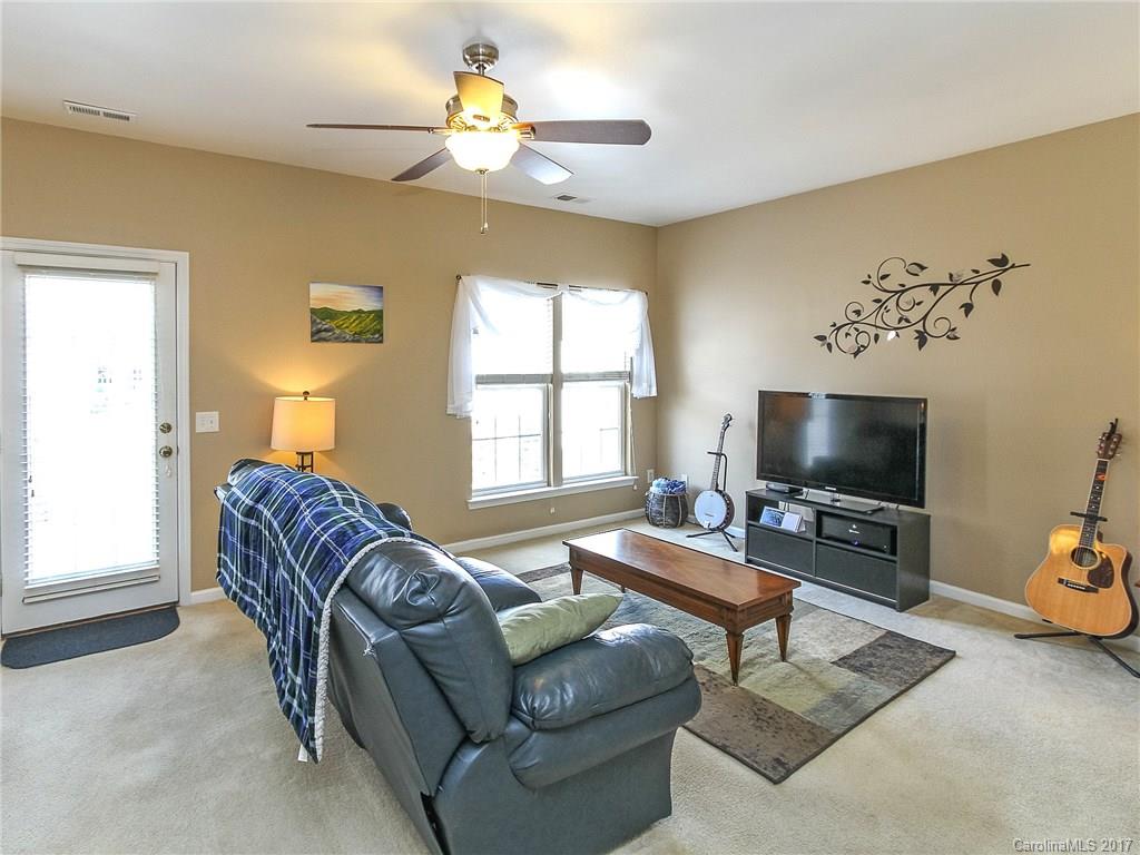 853 Dillard Road, Unit 103 Rock Hill, SC 29730 - Photo 11 of 18 a living room with furniture a flat screen tv and a window