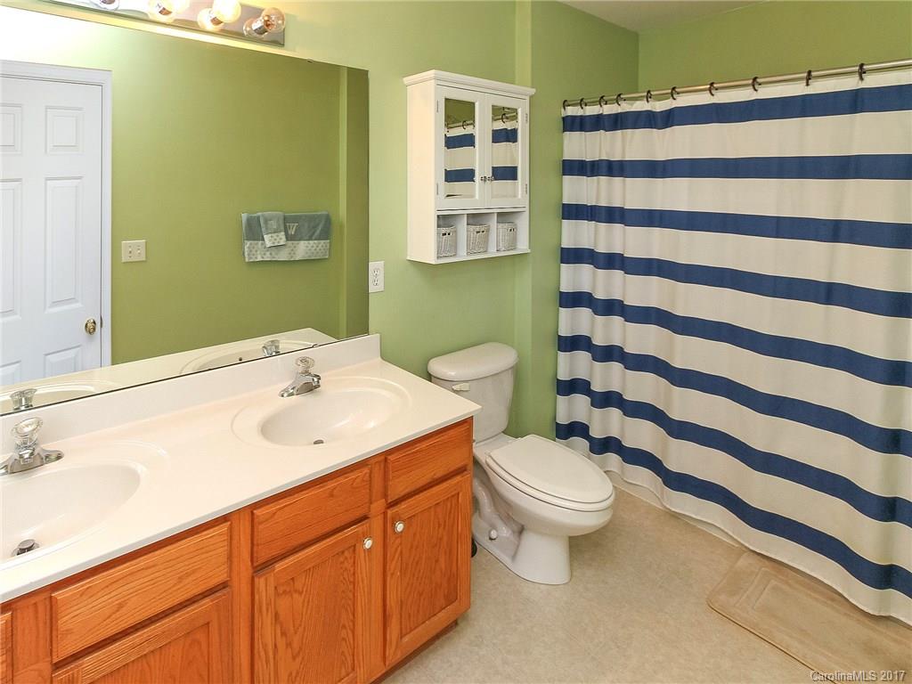 853 Dillard Road, Unit 103 Rock Hill, SC 29730 - Photo 15 of 18 a bathroom with a sink a toilet and shower