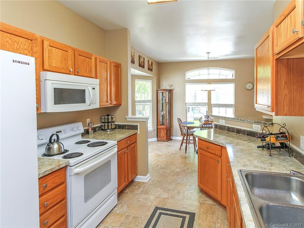 853 Dillard Road, Unit 103 Rock Hill, SC 29730 - Photo 5 of 18 a kitchen with a sink stove and cabinets