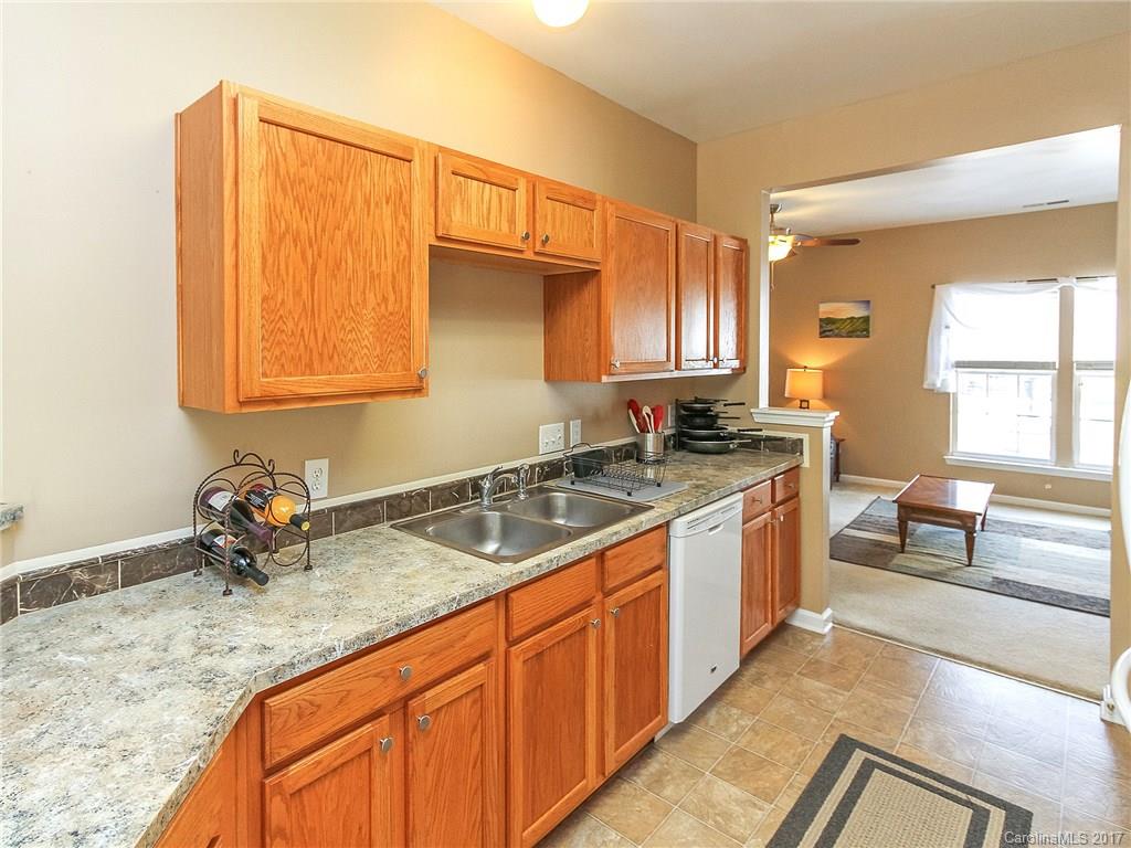 853 Dillard Road, Unit 103 Rock Hill, SC 29730 - Photo 7 of 18 a kitchen with stainless steel appliances granite countertop a sink stove and cabinets