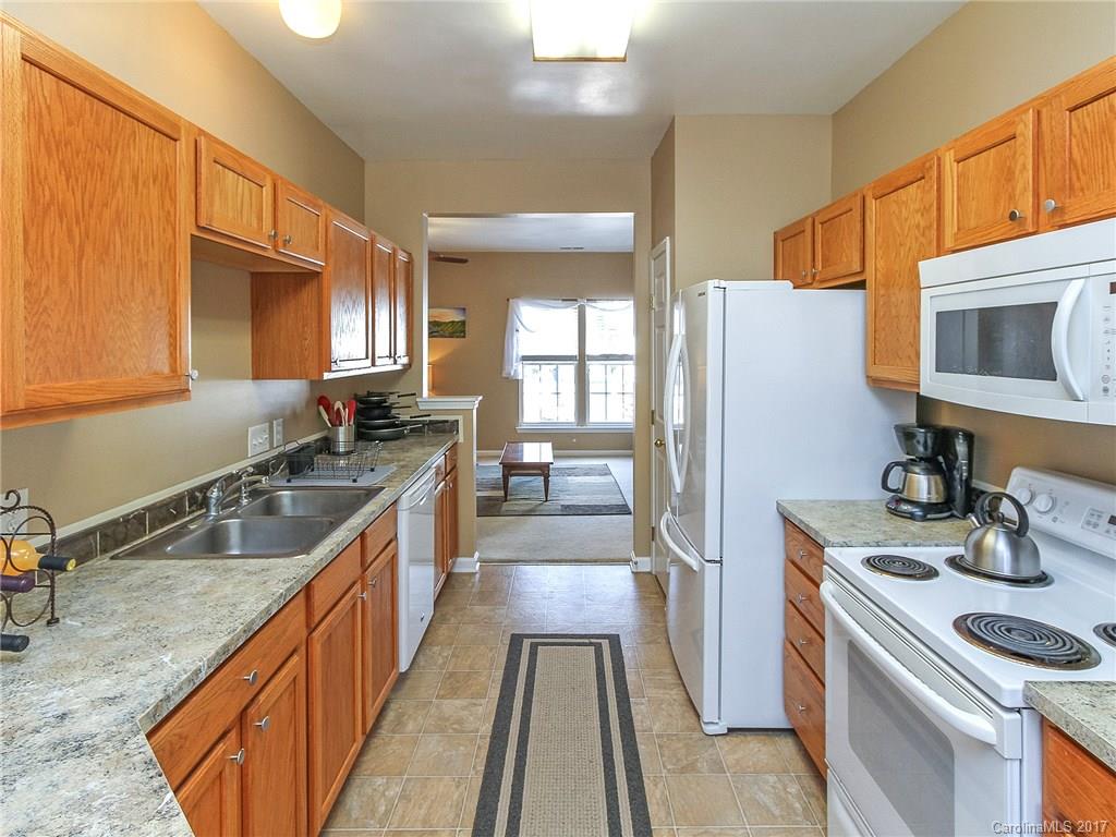 853 Dillard Road, Unit 103 Rock Hill, SC 29730 - Photo 8 of 18 a kitchen with stainless steel appliances granite countertop a sink stove and refrigerator