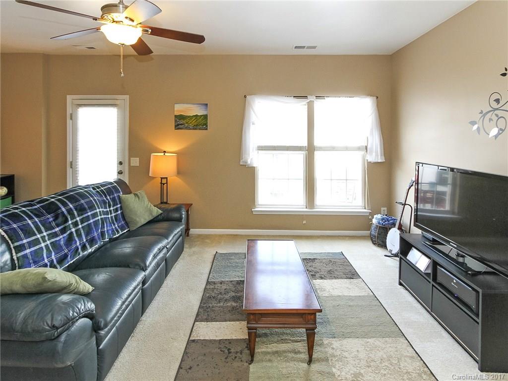 853 Dillard Road, Unit 103 Rock Hill, SC 29730 - Photo 9 of 18 a living room with furniture and a flat screen tv
