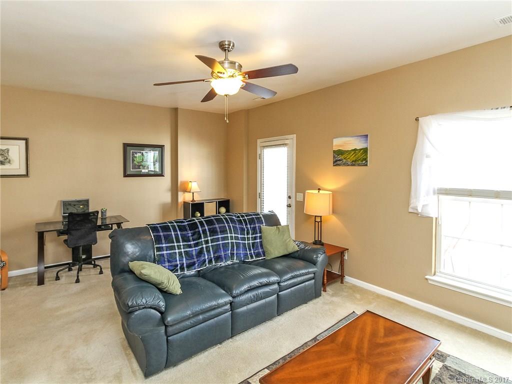 853 Dillard Road, Unit 103 Rock Hill, SC 29730 - Photo 10 of 18 a living room with furniture ceiling fan and a window