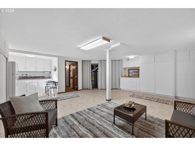 a living room with furniture and a dining table