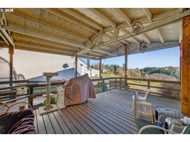 a view of a roof deck with table and chairs a barbeque with wooden floor