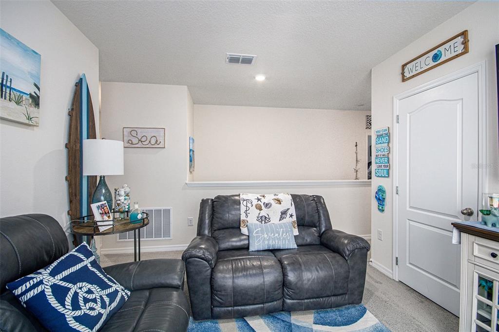 3027 Beau Loop Tavares, FL 32778 - Photo 16 of 30 a living room with furniture and wooden floor