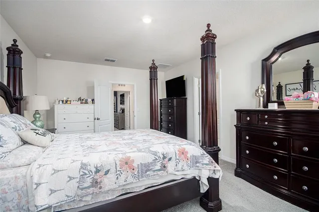 a bedroom with a bed and a dresser