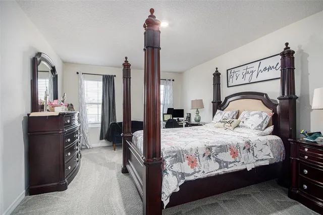 a bedroom with a bed and a mirror