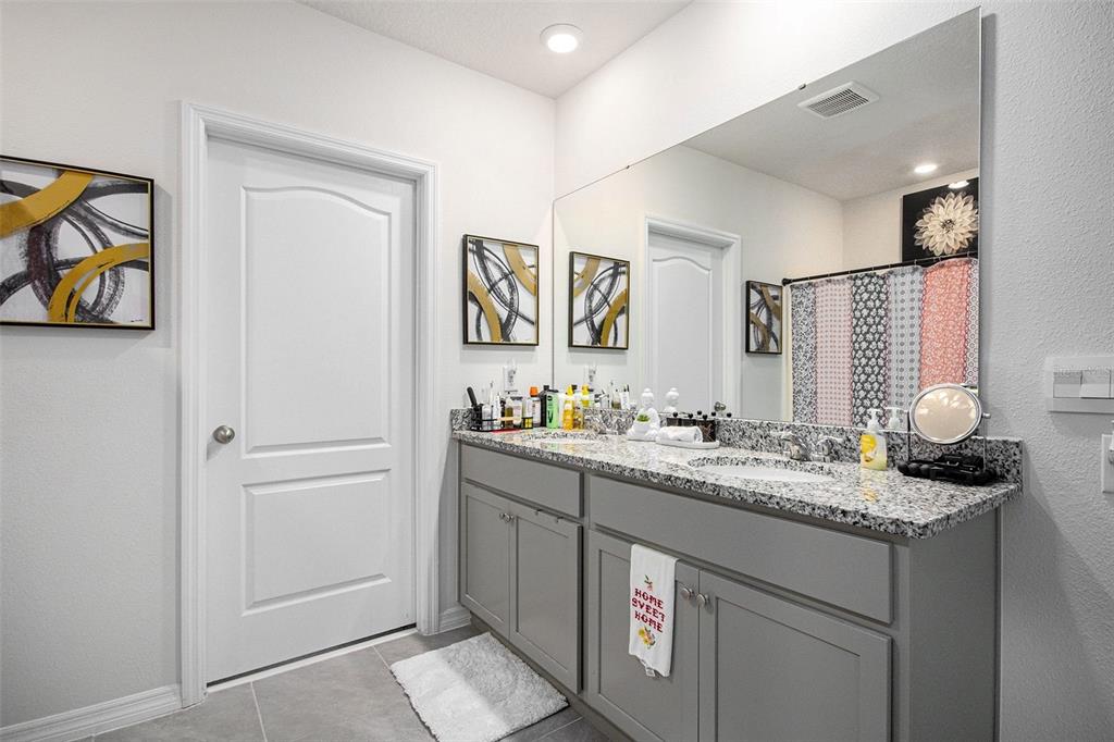 3027 Beau Loop Tavares, FL 32778 - Photo 23 of 30 a bathroom with a sink and a mirror