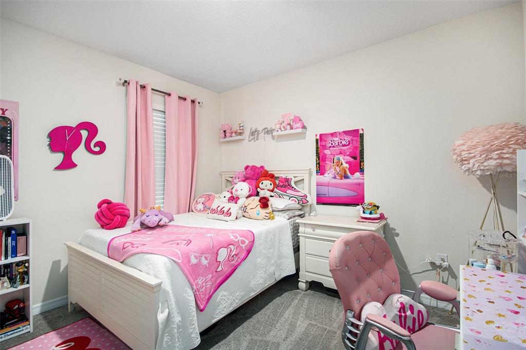 3027 Beau Loop Tavares, FL 32778 - Photo 26 of 30 a bedroom with a bed and a dresser