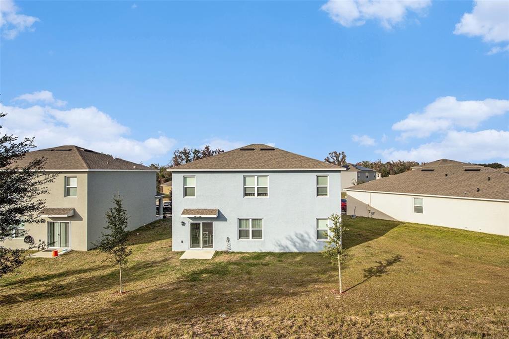 3027 Beau Loop Tavares, FL 32778 - Photo 29 of 30 a view of a house with a yard