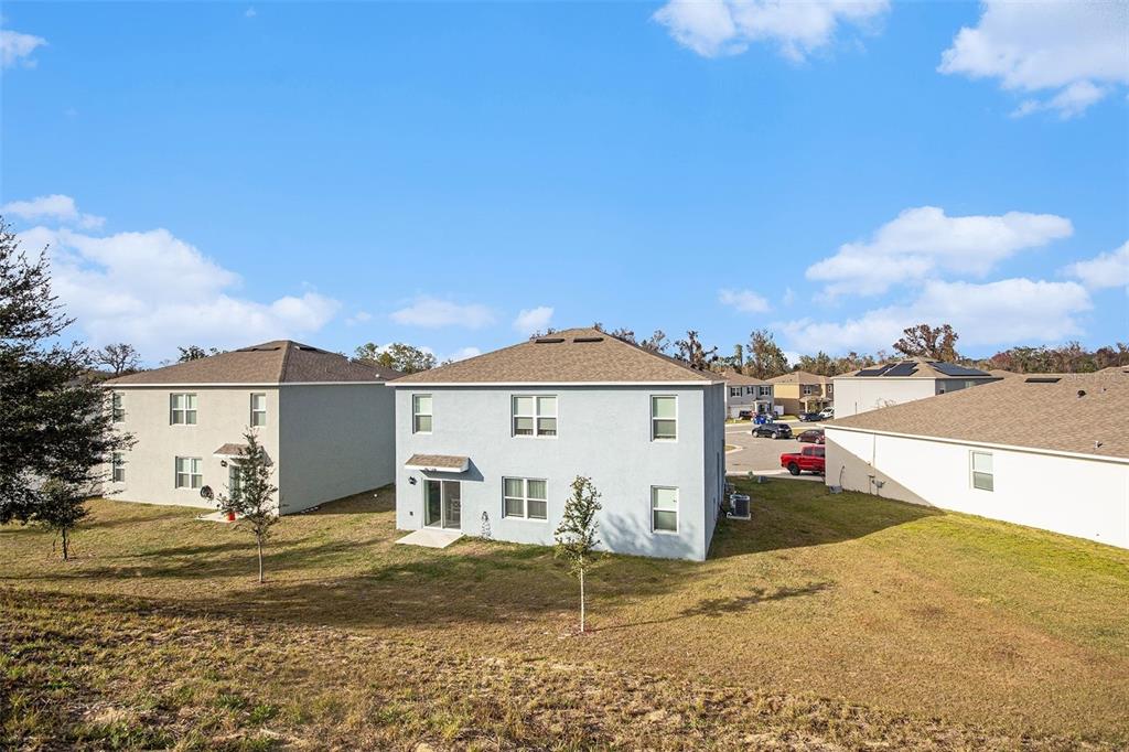 3027 Beau Loop Tavares, FL 32778 - Photo 30 of 30 a view of a house with a yard