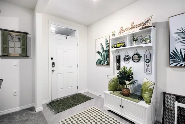 a living room with furniture and flowers