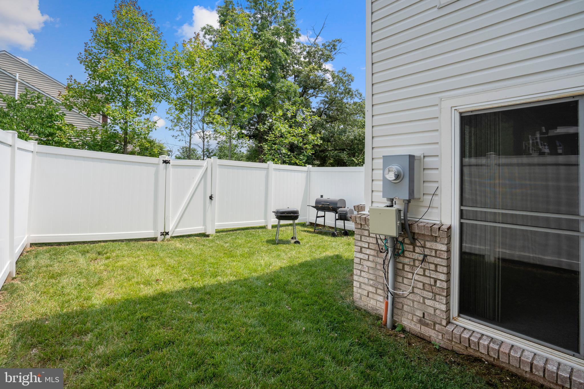 22672 Flowing Spring Square Brambleton, VA 20148 - Photo 4 of 5 a backyard of a house with table and chairs