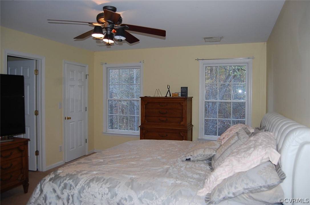 312 Sunset Ridge Drive Farmville, VA 23901 - Photo 18 of 25 a bedroom with a bed dresser and a flat tv screen