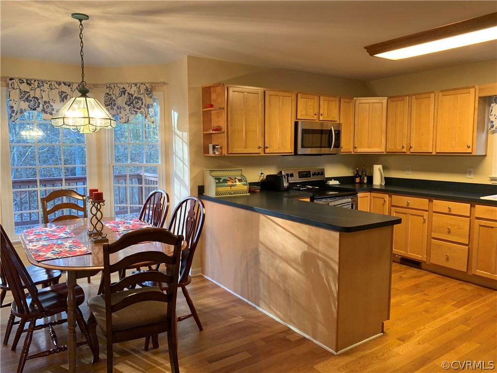 312 Sunset Ridge Drive Farmville, VA 23901 - Photo 6 of 25 a kitchen with stainless steel appliances granite countertop a stove a sink dishwasher a dining table and chairs with wooden floor