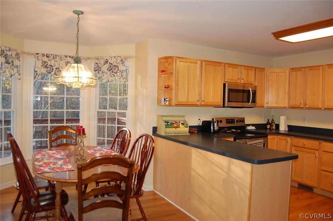 312 Sunset Ridge Drive Farmville, VA 23901 - Photo 8 of 25 a kitchen with stainless steel appliances granite countertop a stove top oven a sink a dining table and chairs