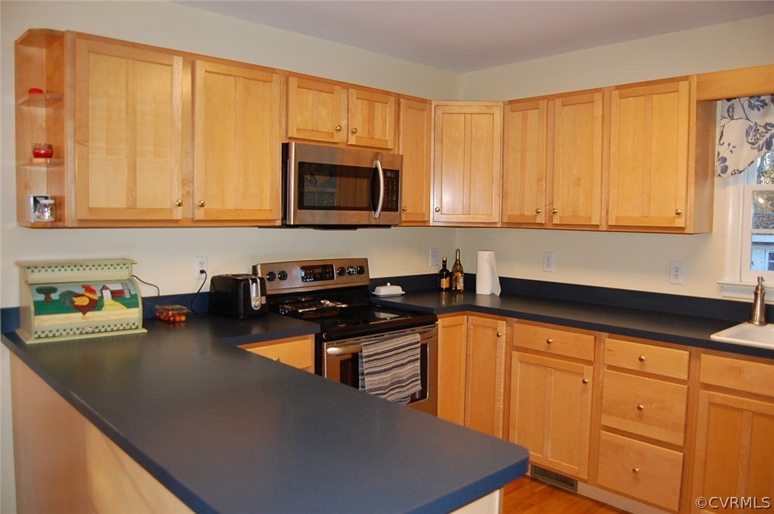 312 Sunset Ridge Drive Farmville, VA 23901 - Photo 9 of 25 a kitchen with stainless steel appliances wooden cabinets and a stove top oven