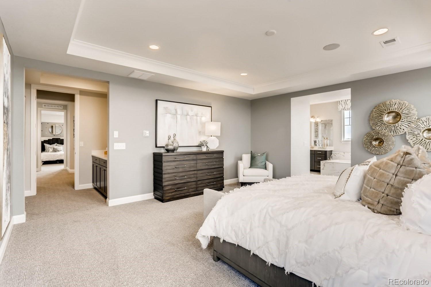 3008 Blithe Point Castle Rock, CO 80108 - Photo 15 of 29 a bedroom with a bed and a chandelier