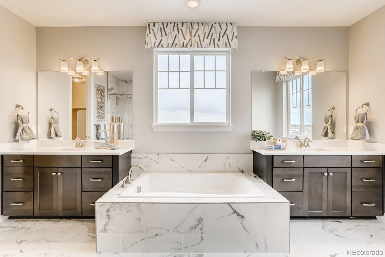 3008 Blithe Point Castle Rock, CO 80108 - Photo 16 of 29 a spacious bathroom with a tub sink shower and mirror