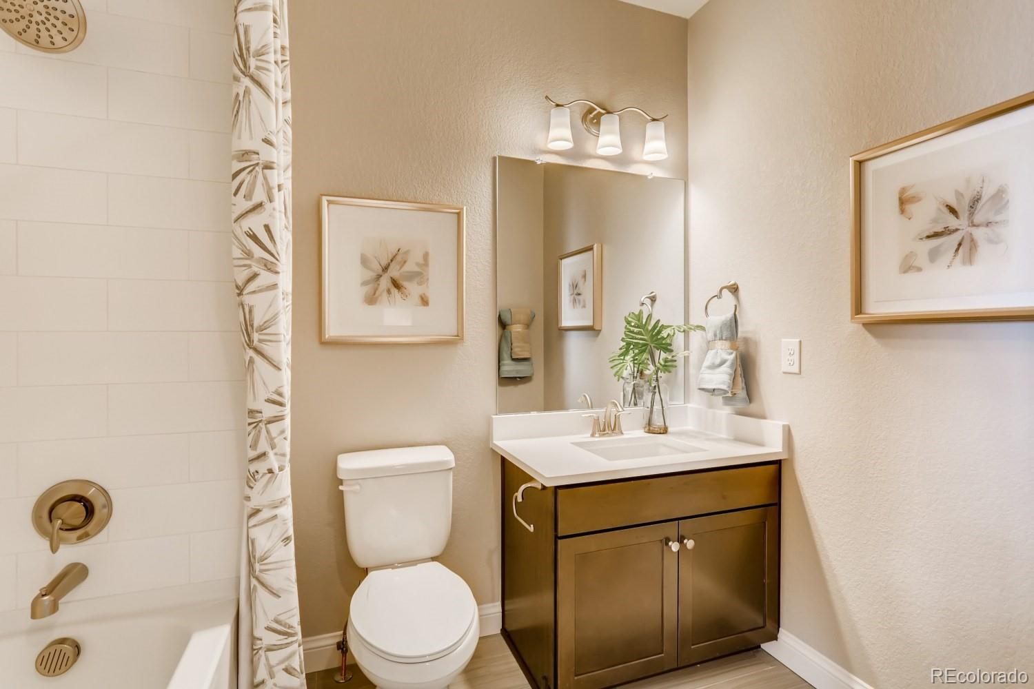3008 Blithe Point Castle Rock, CO 80108 - Photo 19 of 29 a bathroom with a toilet sink and mirror
