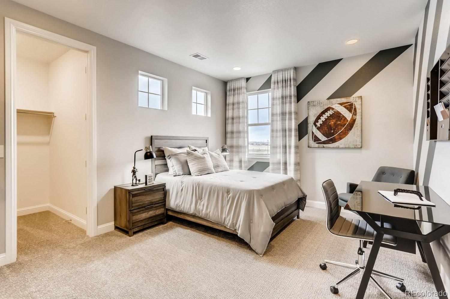 3008 Blithe Point Castle Rock, CO 80108 - Photo 21 of 29 a bedroom with a bed and a chair
