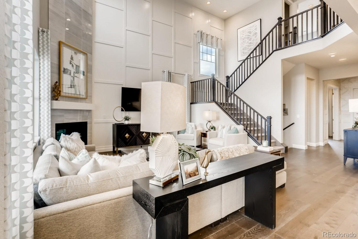 3008 Blithe Point Castle Rock, CO 80108 - Photo 5 of 29 a living room with furniture a fireplace and a flat screen tv