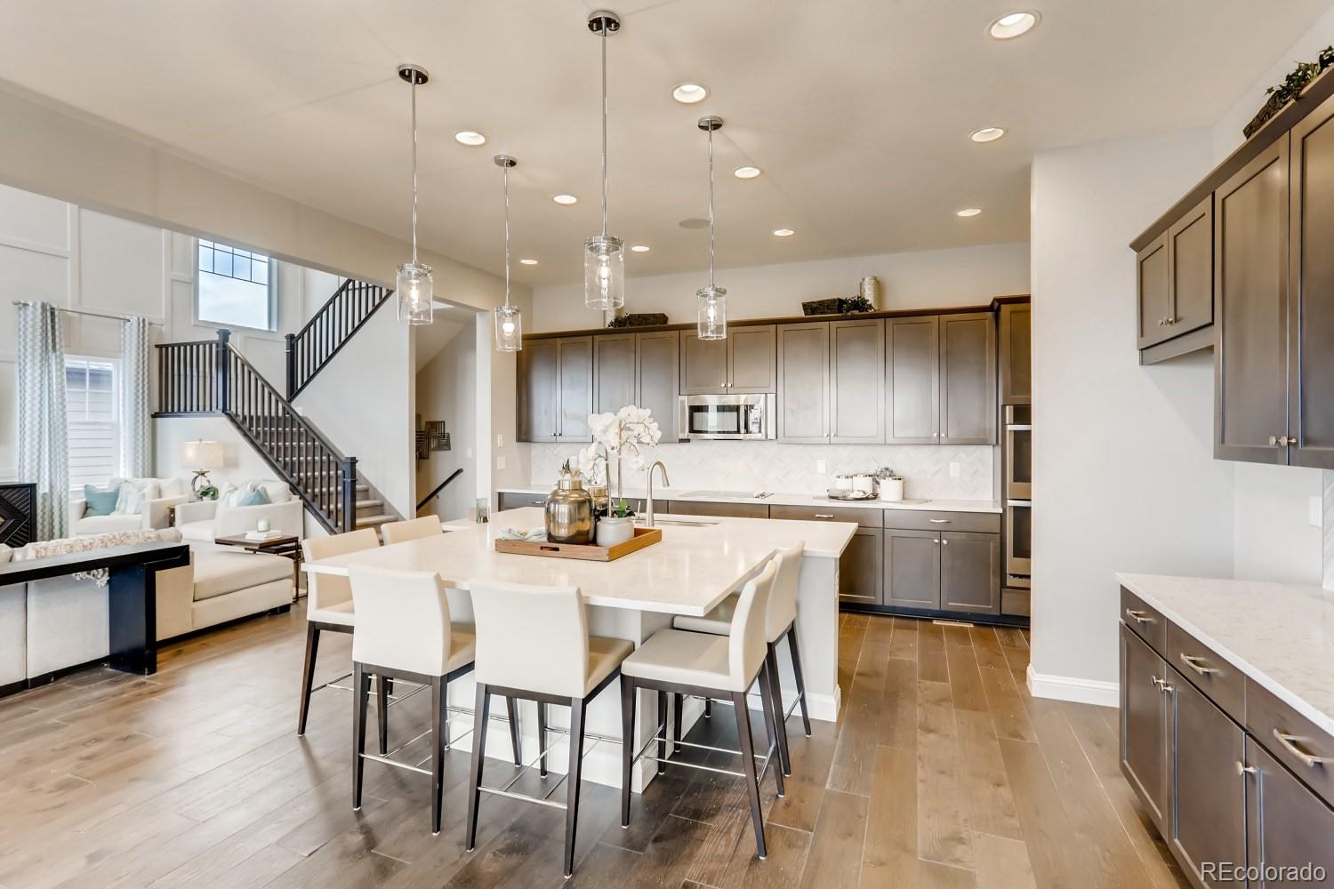 3008 Blithe Point Castle Rock, CO 80108 - Photo 10 of 29 a large kitchen with a table and chairs in it