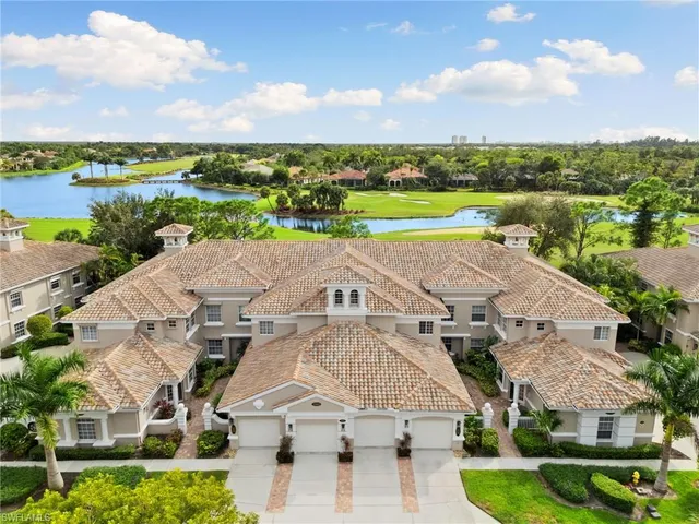 an aerial view of a house with a garden and lake view