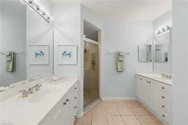 a spacious bathroom with a double vanity sink mirror and shower