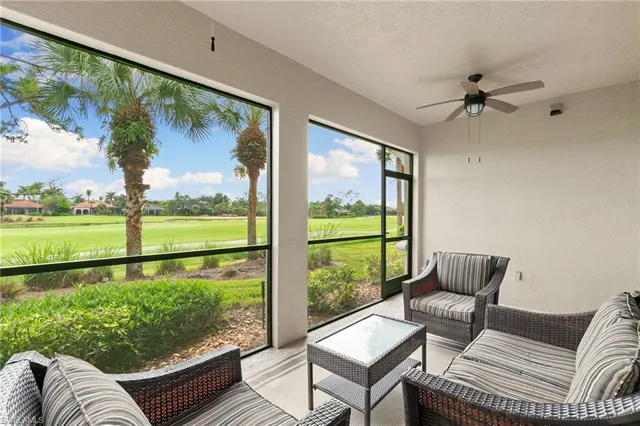a living room with furniture and a floor to ceiling window