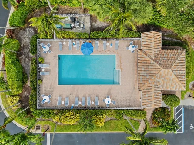 a view of backyard with swimming pool and outdoor seating