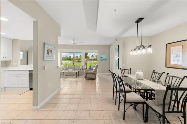 a view of a dining room with furniture and a chandelier