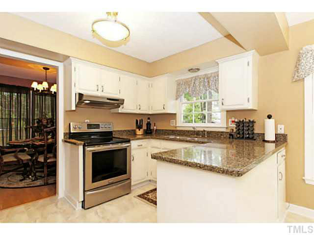 2008 Port Royal Road Raleigh, NC 27609 - Photo 8 of 25 Upgraded Kitchen includes granite countertops and stainless steel appliances. Great Lighting solid cabinets.