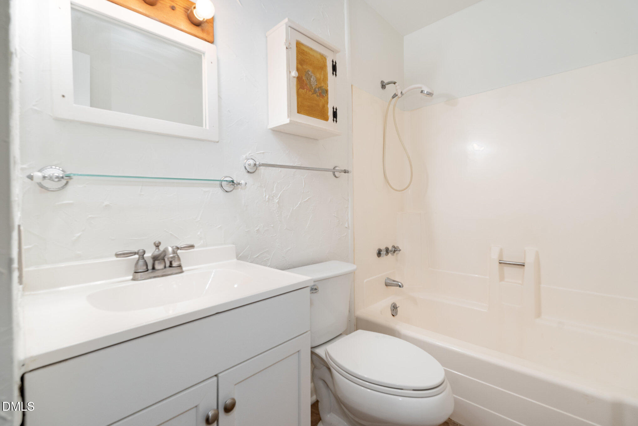 5920 Farm Gate Road Raleigh, NC 27606 - Photo 12 of 16 a bathroom with a sink toilet vanity and shower