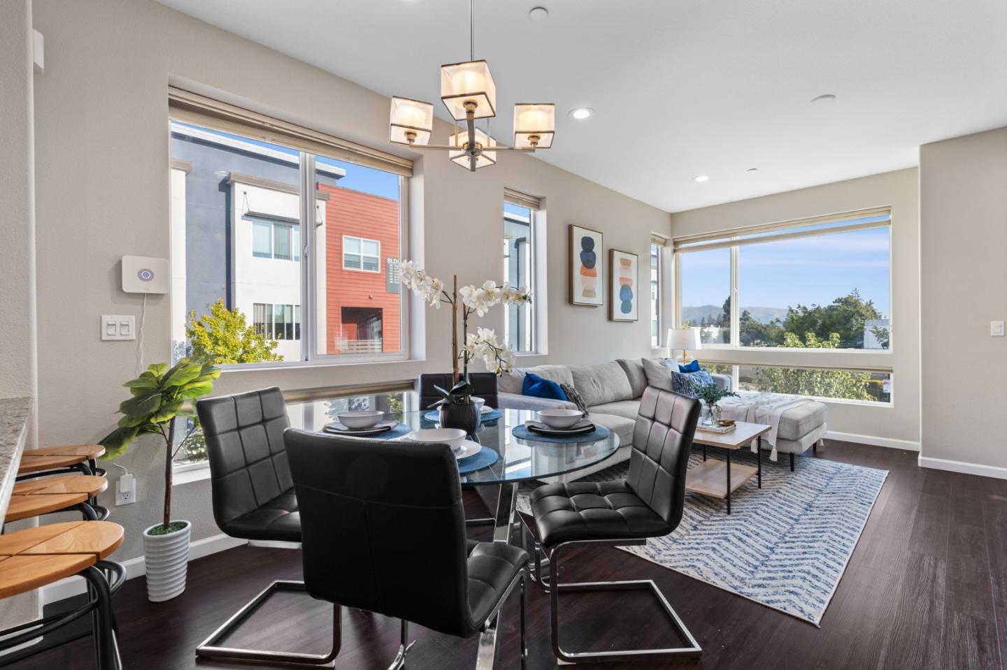 402 Ellicott Loop San Jose, CA 95123 - Photo 12 of 33 a dining room with wooden floor a chandelier a glass table and chairs