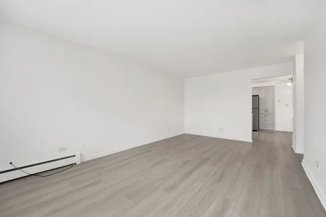 a view of an empty room and wooden floor