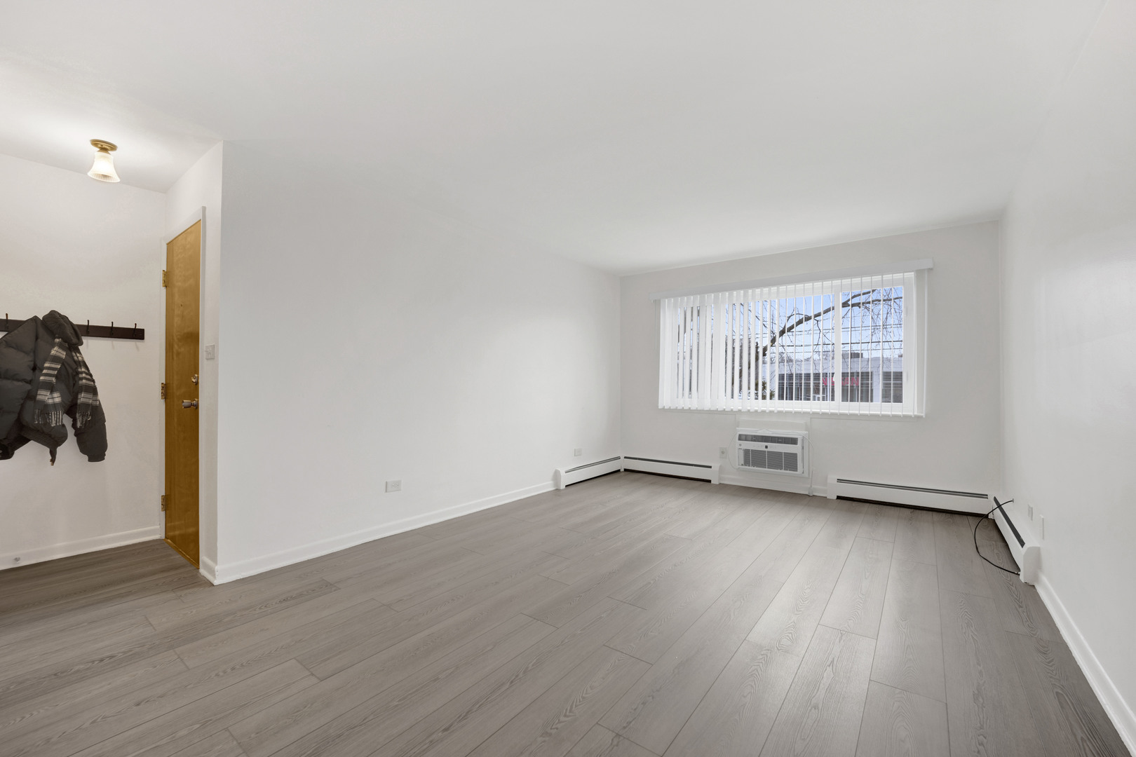 1608 Ogden Avenue, Unit 1E Downers Grove, IL 60515 - Photo 15 of 18 an empty room with wooden floor and windows