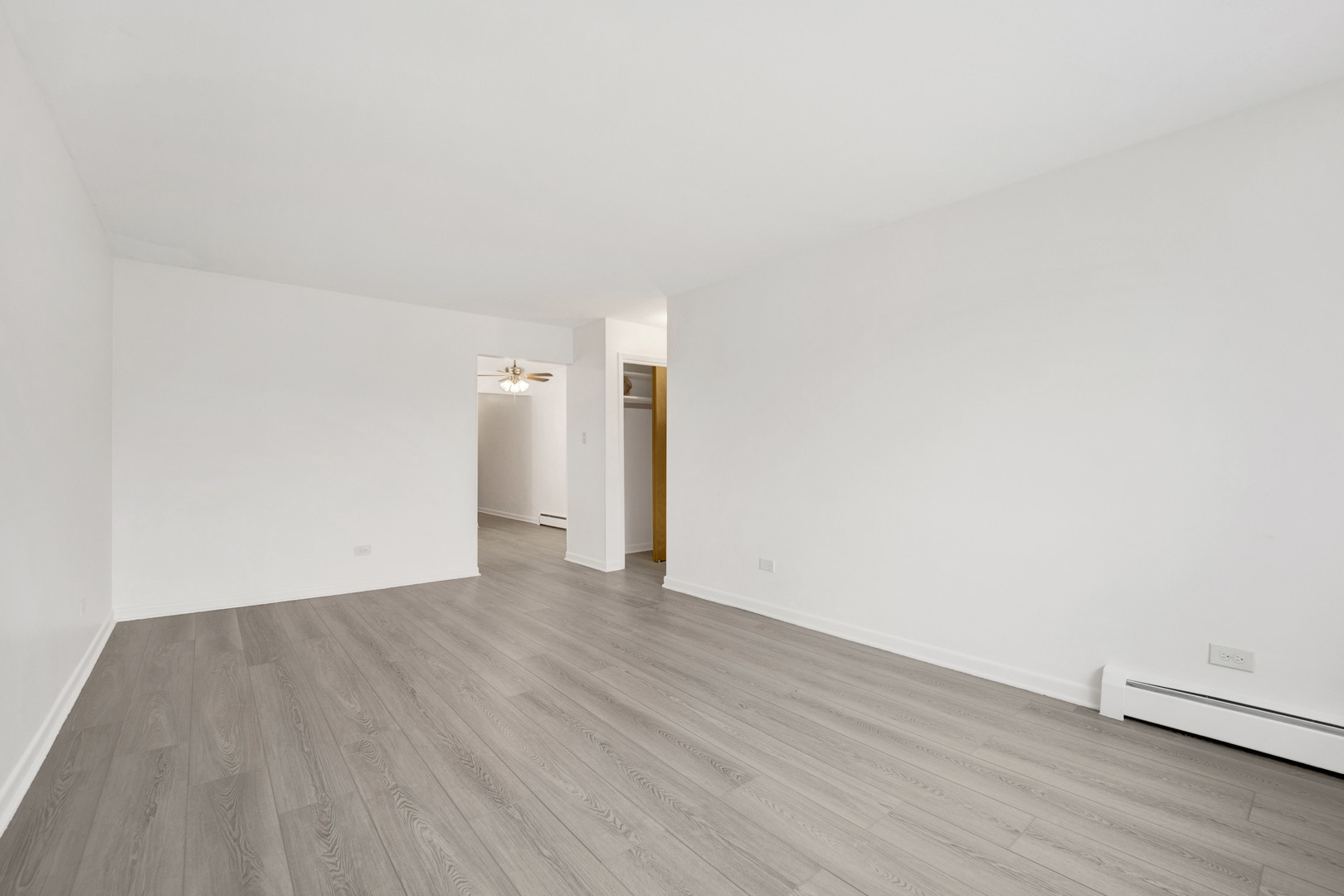 1608 Ogden Avenue, Unit 1E Downers Grove, IL 60515 - Photo 16 of 18 a view of an empty room with wooden floor