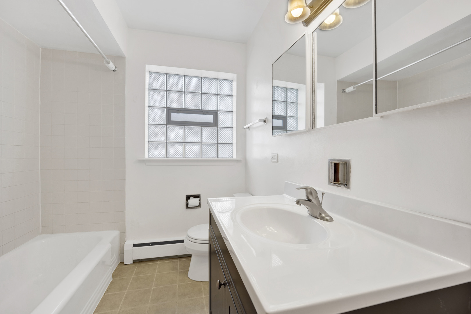 1608 Ogden Avenue, Unit 1E Downers Grove, IL 60515 - Photo 7 of 18 a bathroom with a sink a bathtub and a shower