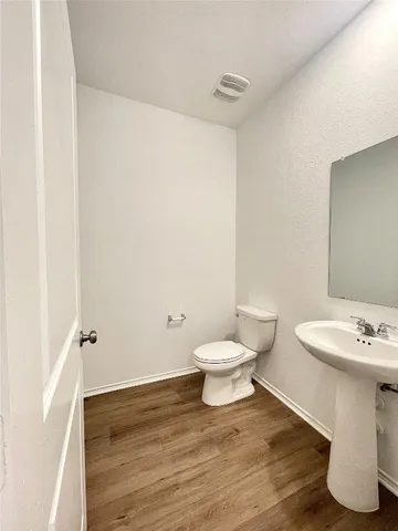 a bathroom with a sink toilet a mirror and shower