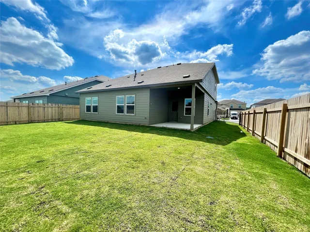 a view of a house with a backyard